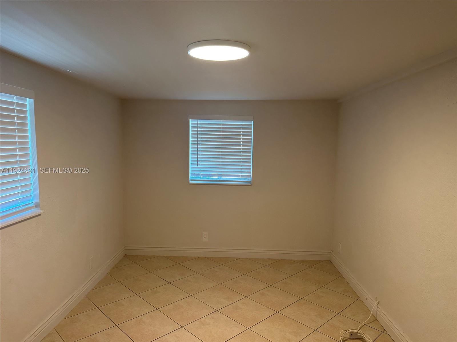 1264 Northeast 25th Court Pompano Beach, FL 33064 - Photo 11 of 19 an empty room with a window