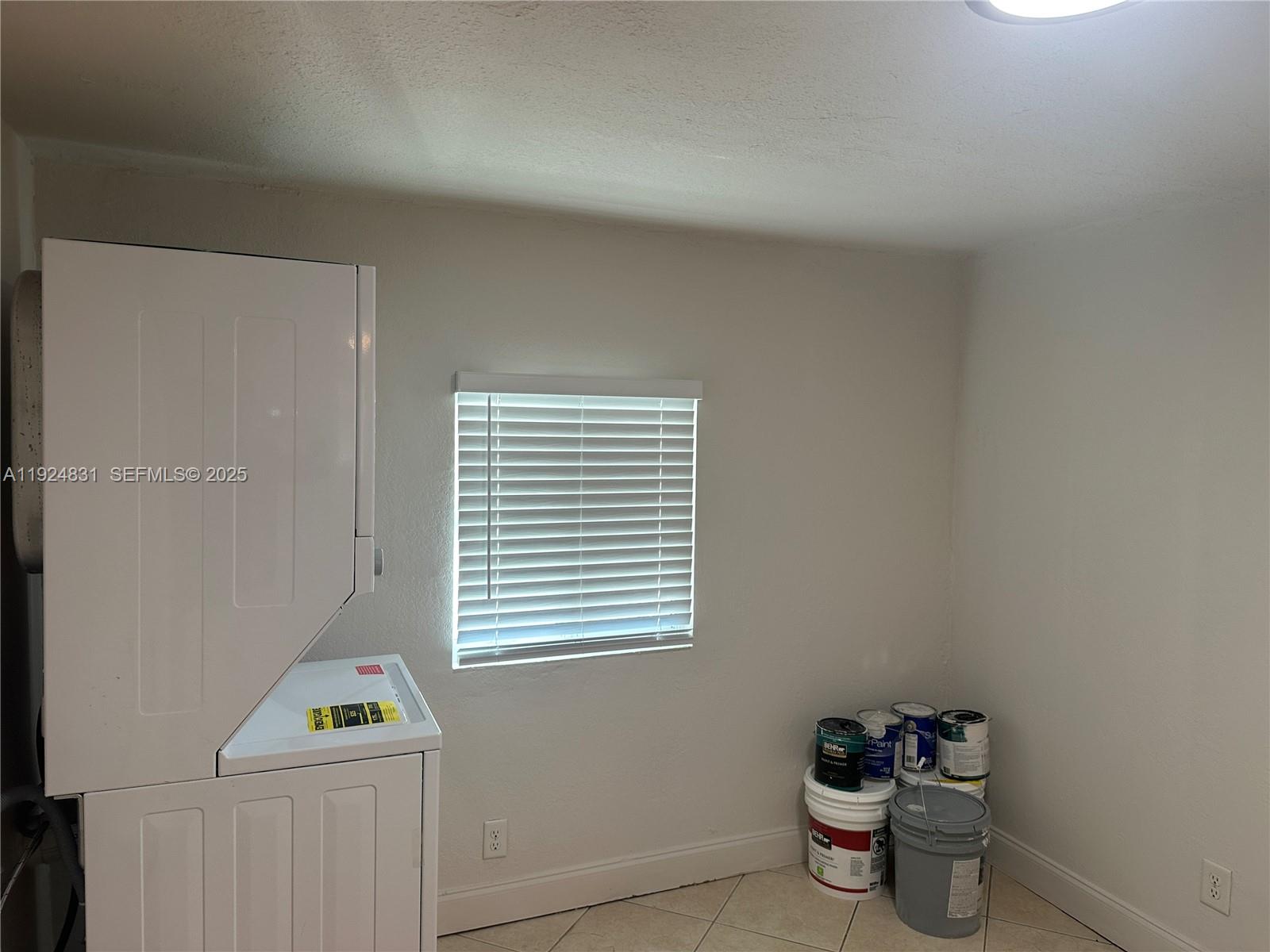1264 Northeast 25th Court Pompano Beach, FL 33064 - Photo 13 of 19 a bathroom with a toilet a sink and a window