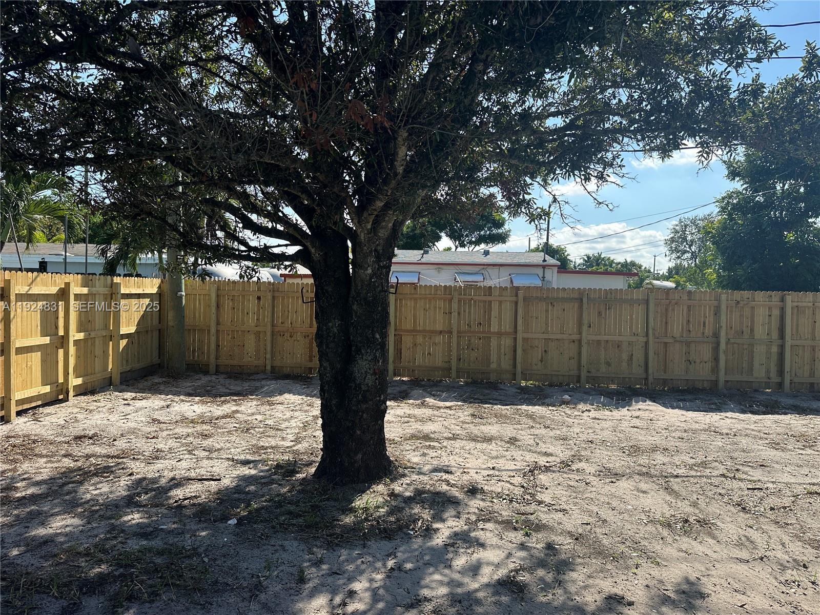 1264 Northeast 25th Court Pompano Beach, FL 33064 - Photo 16 of 19 a view of outdoor space with wooden fence