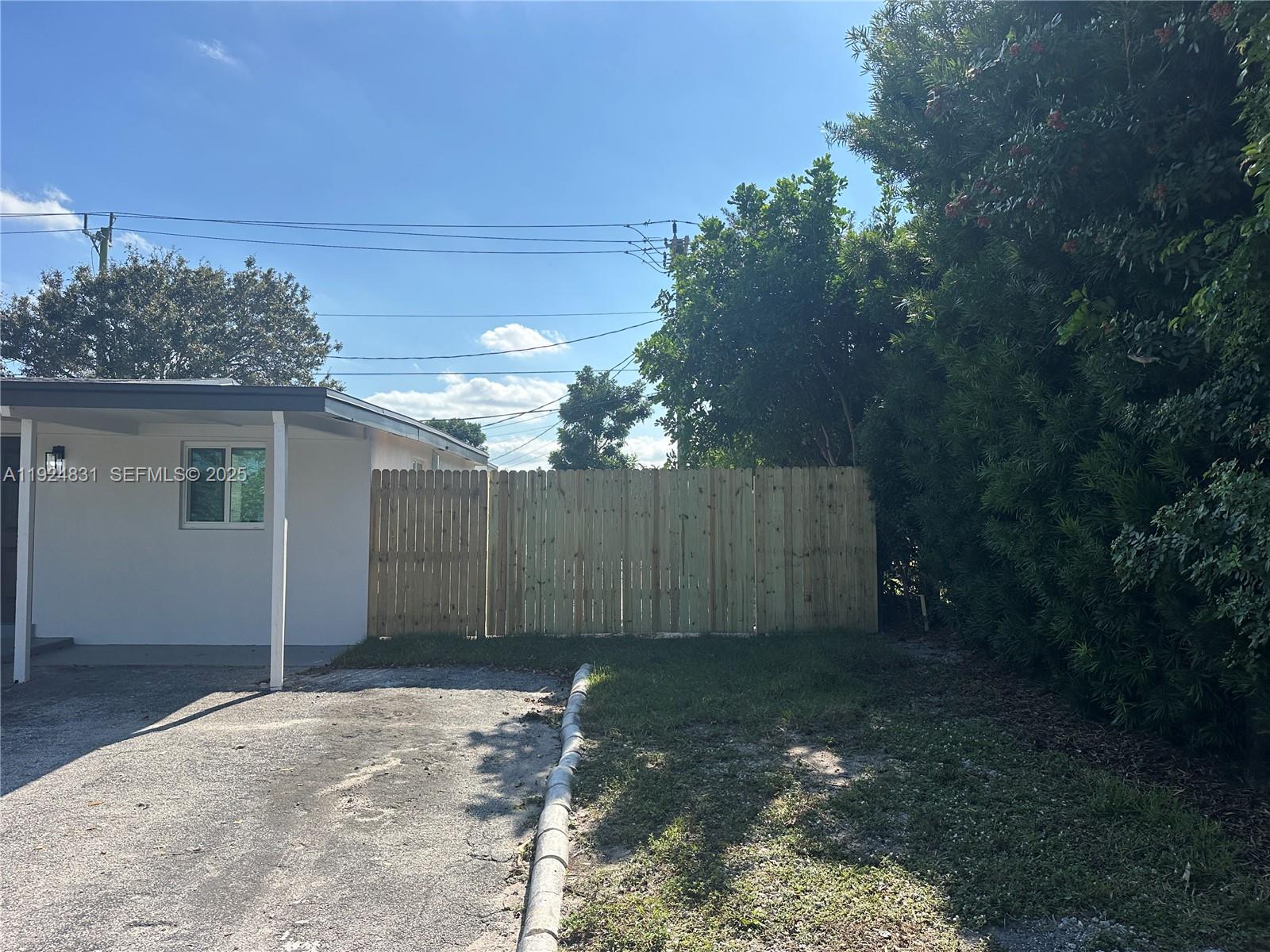 1264 Northeast 25th Court Pompano Beach, FL 33064 - Photo 3 of 19 a view of a backyard of the house