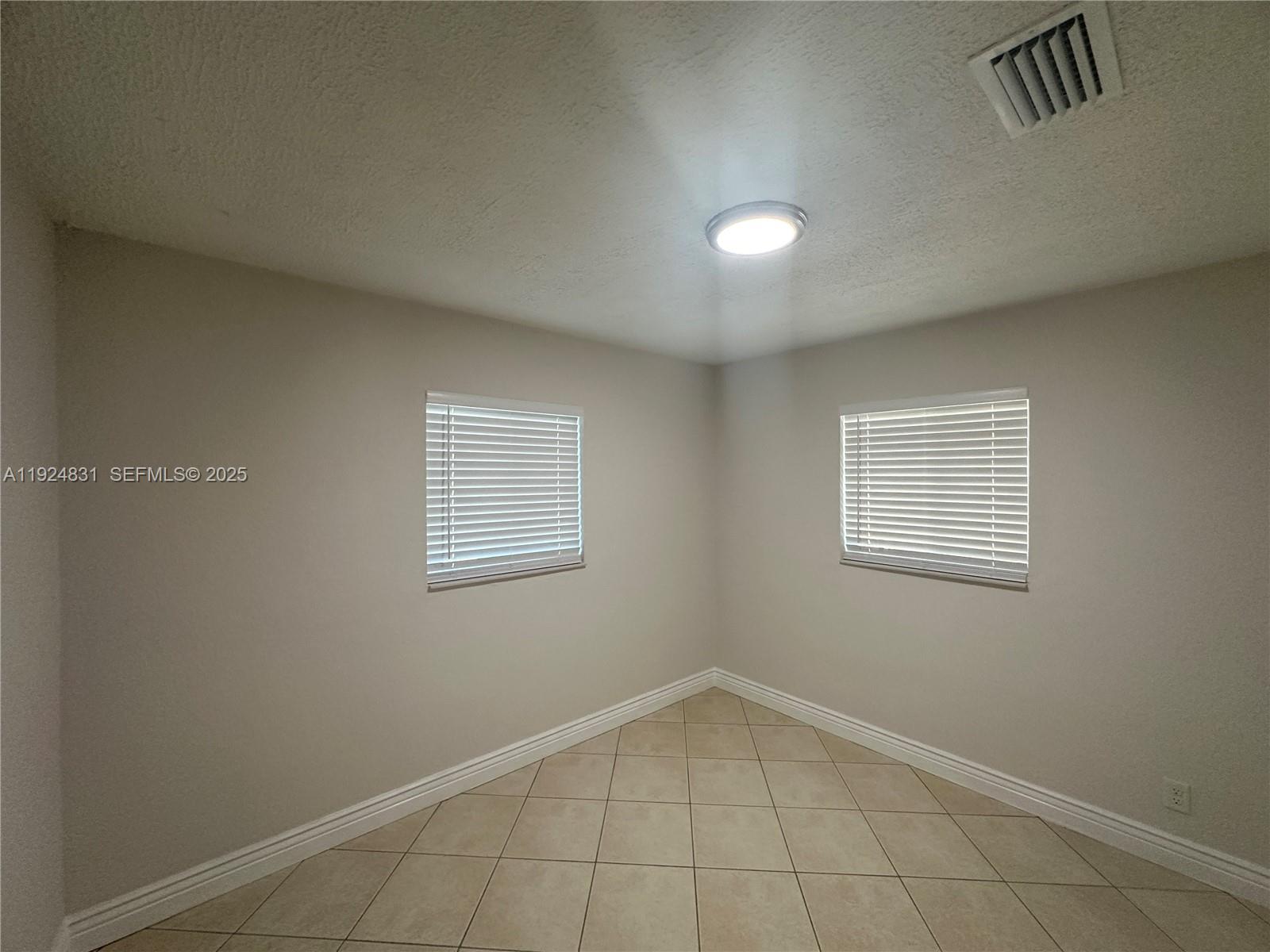 1264 Northeast 25th Court Pompano Beach, FL 33064 - Photo 6 of 19 an empty room with a empty space and window