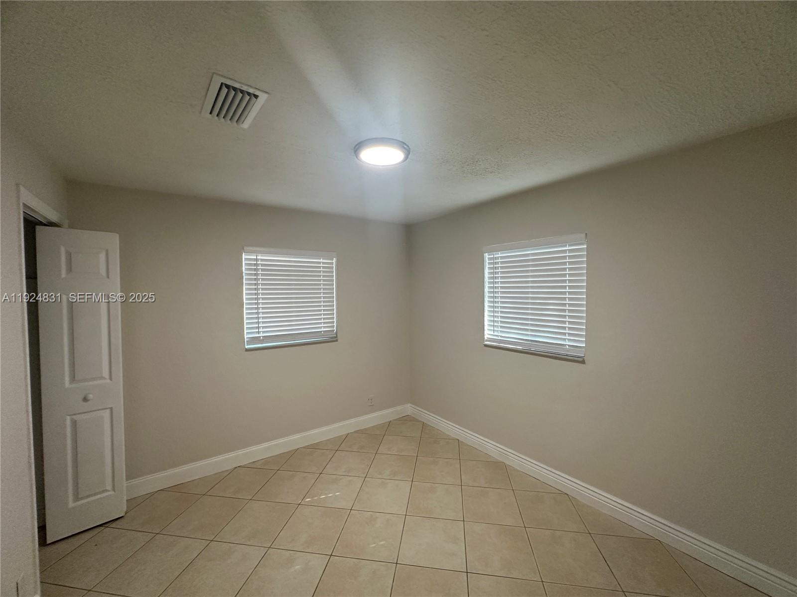 1264 Northeast 25th Court Pompano Beach, FL 33064 - Photo 8 of 19 a view of an empty room with a window