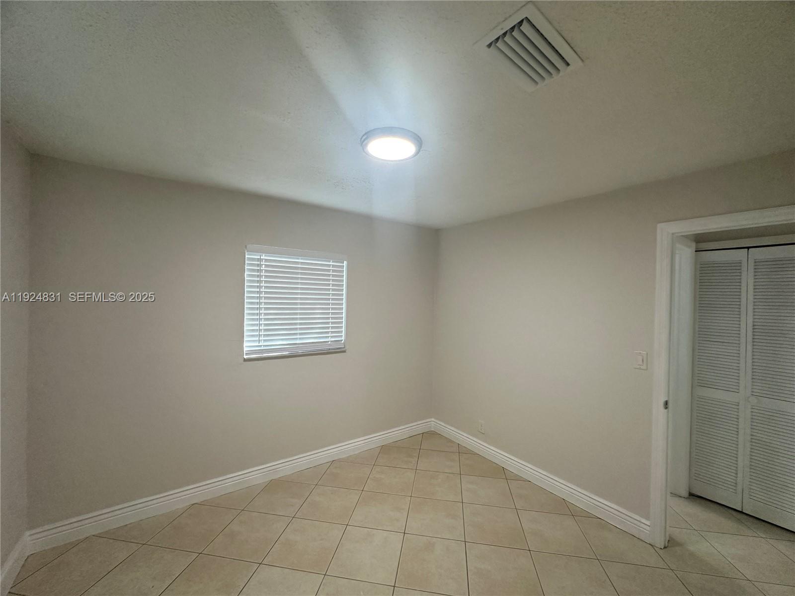 1264 Northeast 25th Court Pompano Beach, FL 33064 - Photo 9 of 19 an empty room with a empty space
