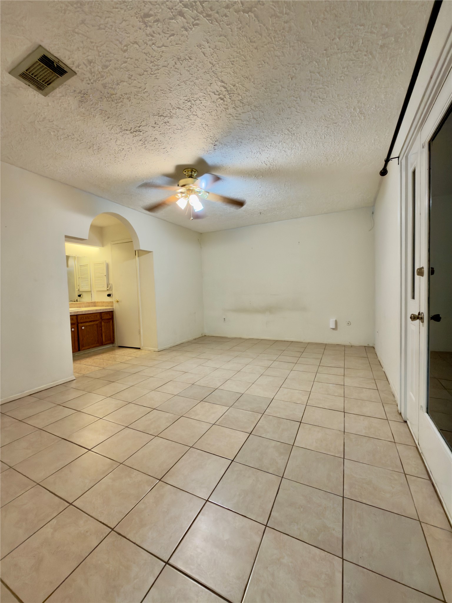 23115 Bright Star Road Spring, TX 77373 - Photo 13 of 14 an empty room with a chandelier fan and windows