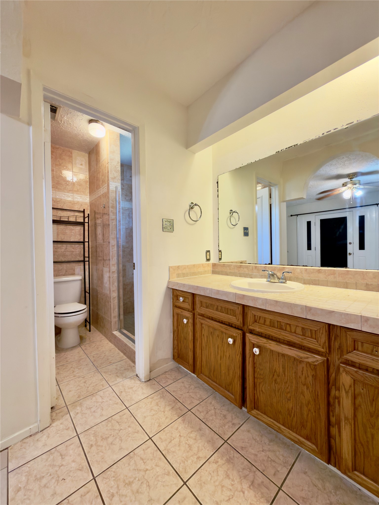 23115 Bright Star Road Spring, TX 77373 - Photo 14 of 14 a spacious bathroom with a granite countertop sink a toilet and a mirror