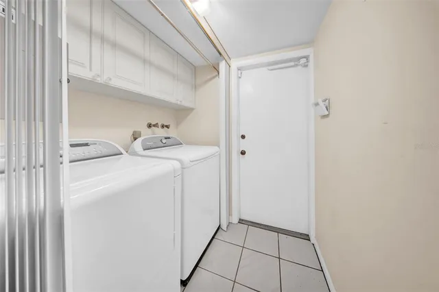 a utility room with closet dryer and washer