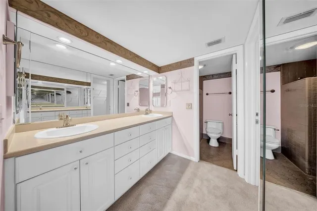 a spacious bathroom with a double vanity sink mirror and double