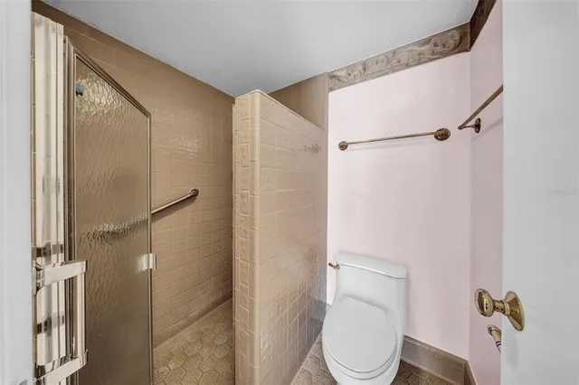 a white toilet sitting next to a bathroom sink