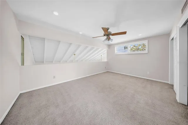 a view of a hallway with a ceiling fan