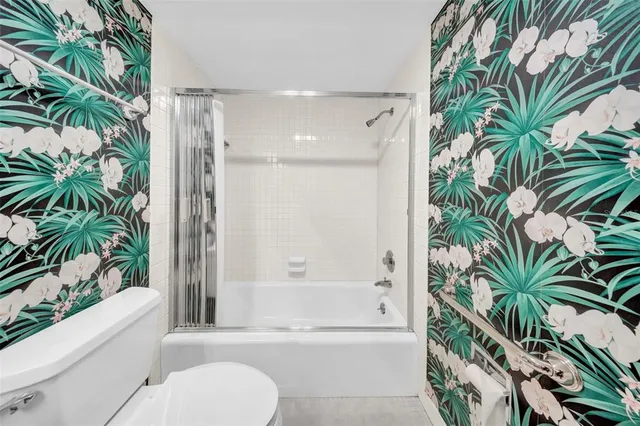 a bathroom with a potted plant and a bathtub