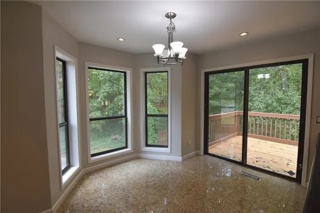 a view of a room with a large bed and chandelier