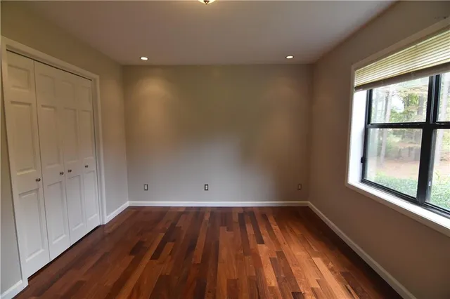 wooden floor in an empty room with a window