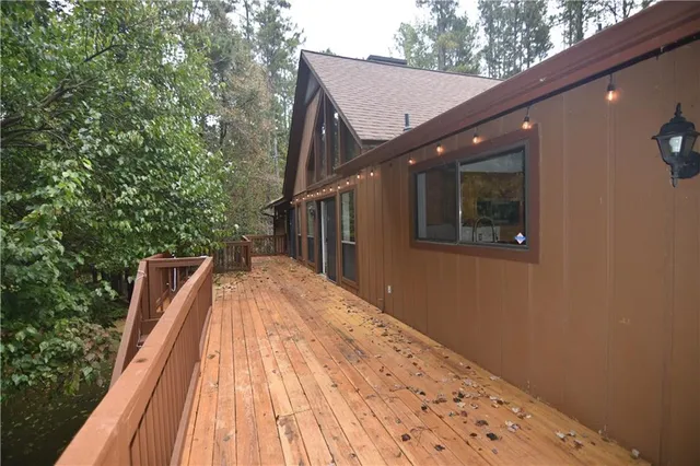 a view of balcony with wooden floor and fence