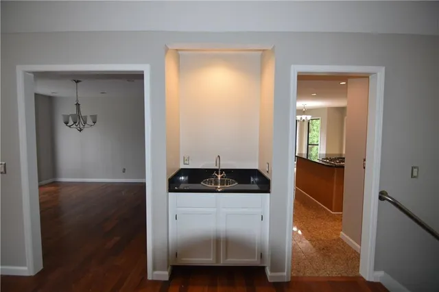 a kitchen with granite countertop a sink and a stove top oven