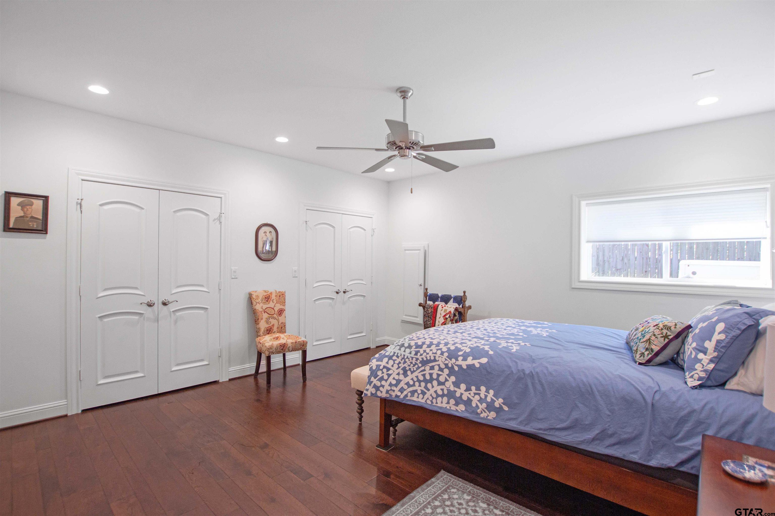 15722 Timberhill Drive Flint, TX 75762 - Photo 30 of 48 a bedroom with a bed and a chandelier