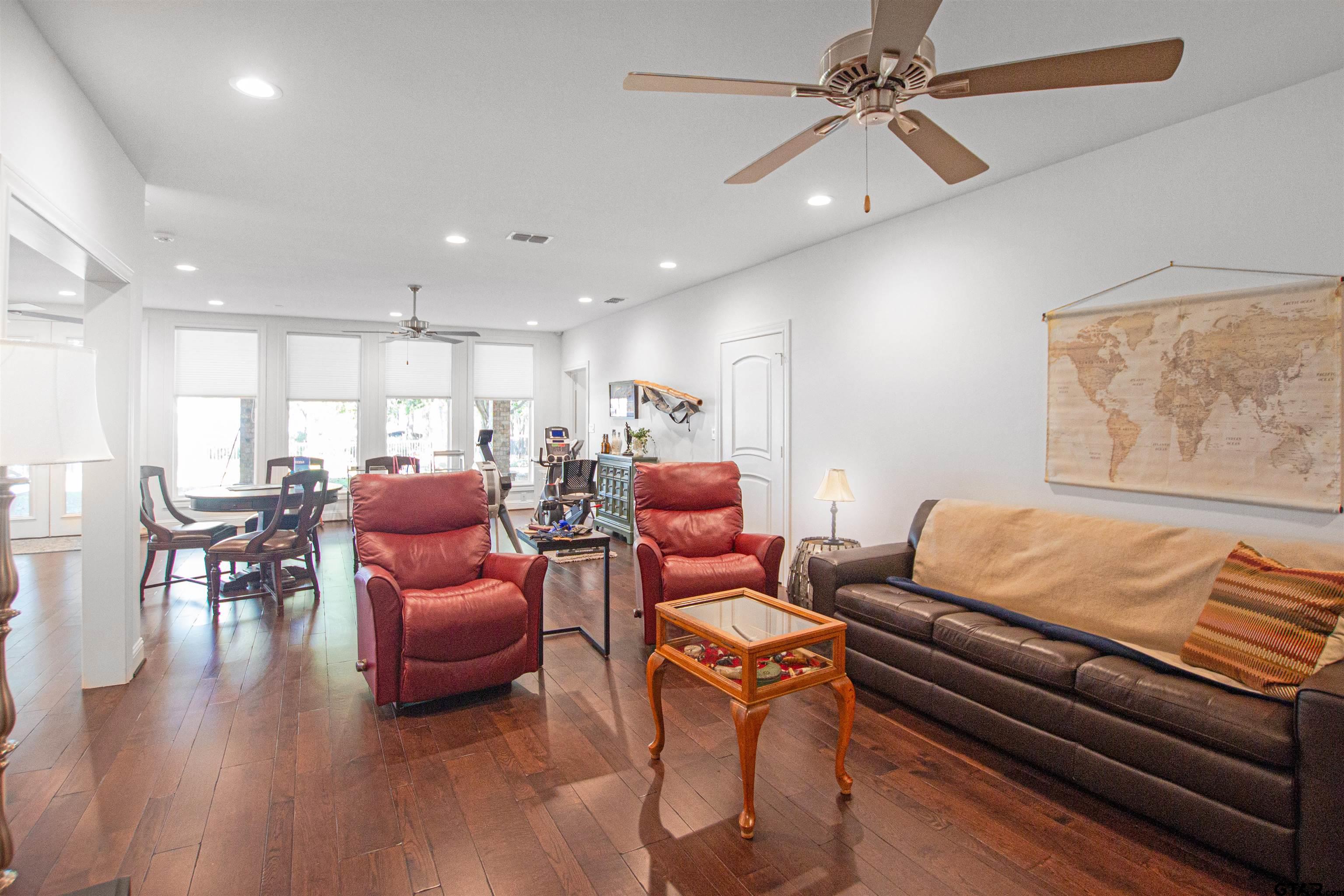 15722 Timberhill Drive Flint, TX 75762 - Photo 36 of 48 a living room with furniture ceiling fan and a wooden floor