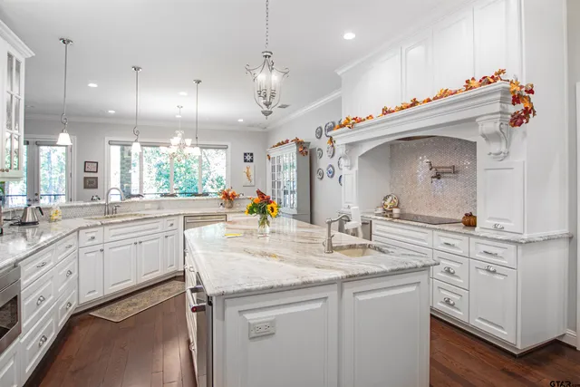 a kitchen with kitchen island a sink and a stove top oven