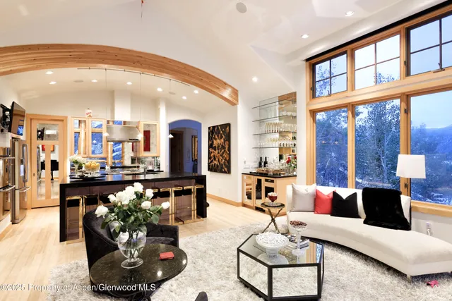 a living room with furniture and a chandelier