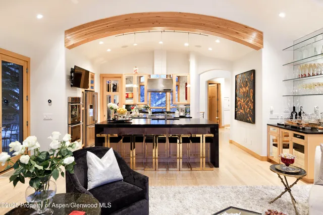 a bedroom with a bed a fireplace and a large window