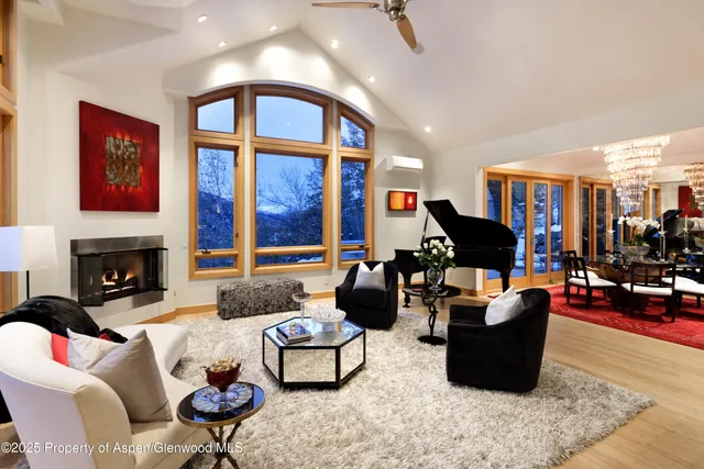 a living room with furniture large window and a flat screen tv
