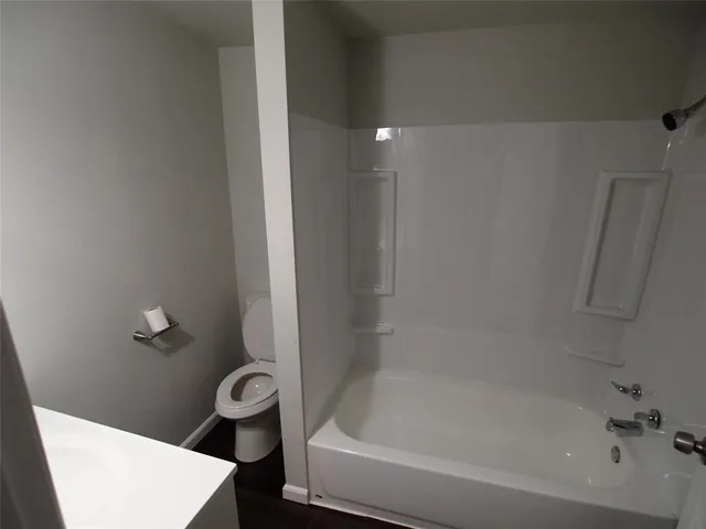 a bath tub sitting next to a toilet