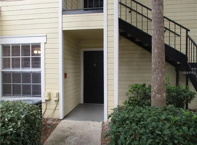 a living room with furniture dining area and a large window
