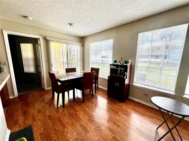 a view of a dining room with furniture window and wooden floor