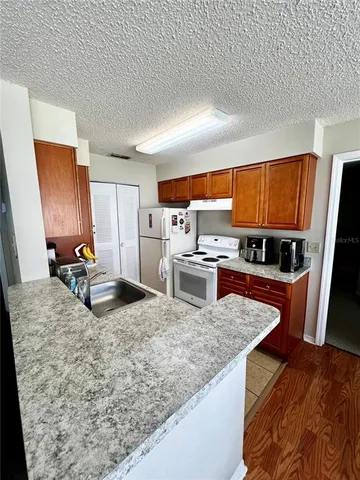 a kitchen with a sink stove and a refrigerator