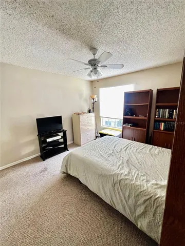 a spacious bedroom with a bed and dresser