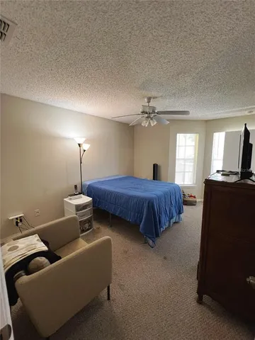 a bedroom with a bed and gym equipment