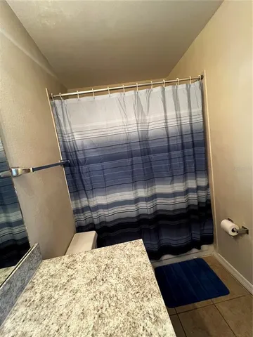 a bathroom with a sink toilet mirror and shower