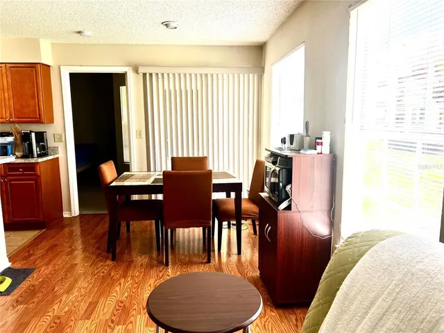 a view of a dining room with furniture window and wooden floor