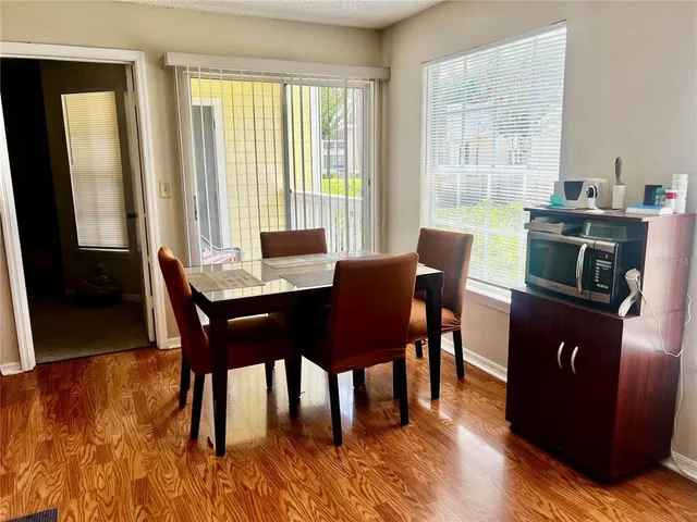 a bedroom with a bed and a couch next to a window