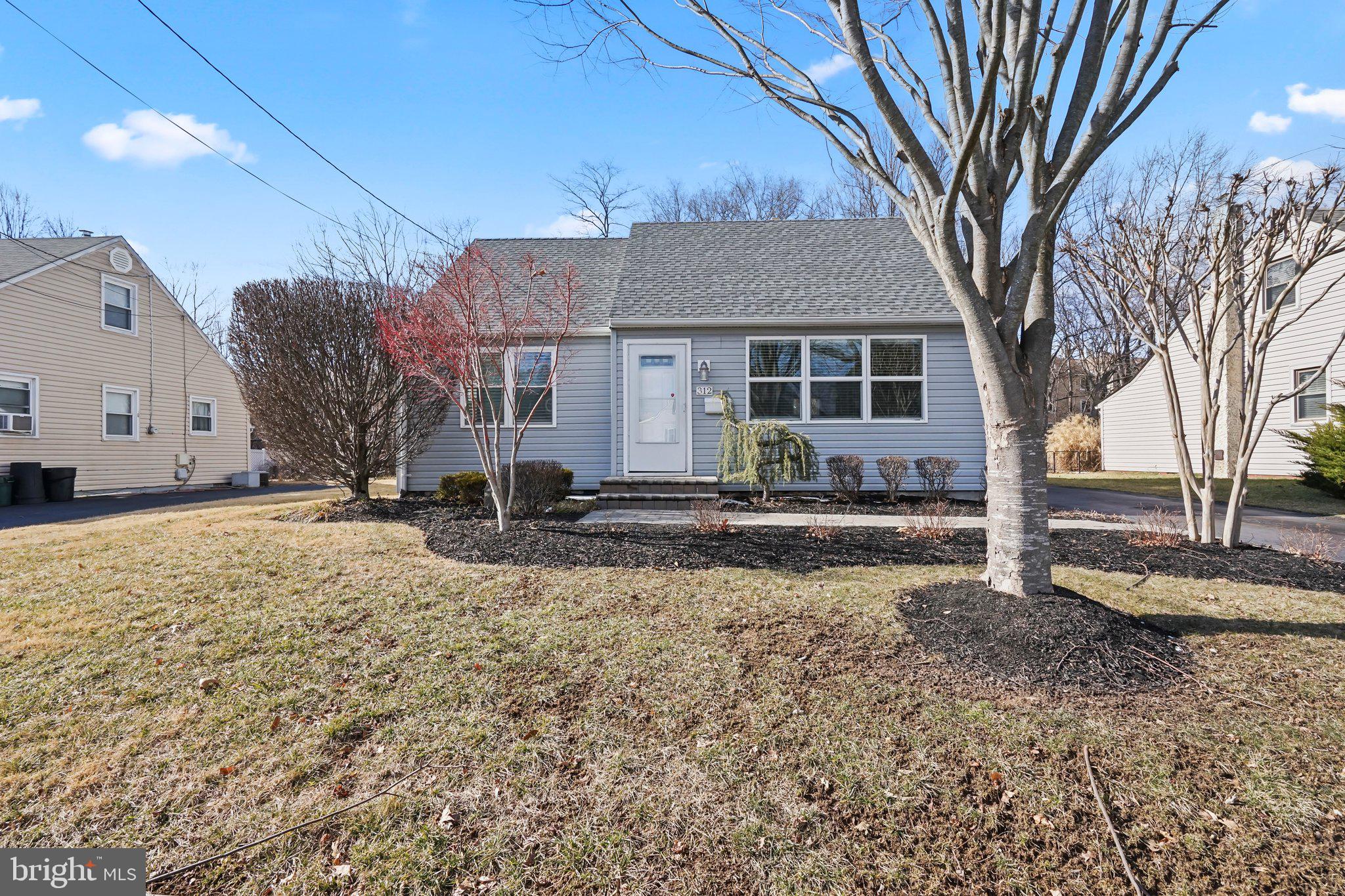 312 Wynnewood Road Ewing, NJ 08628 - Photo 1 of 24 a front view of a house with a yard