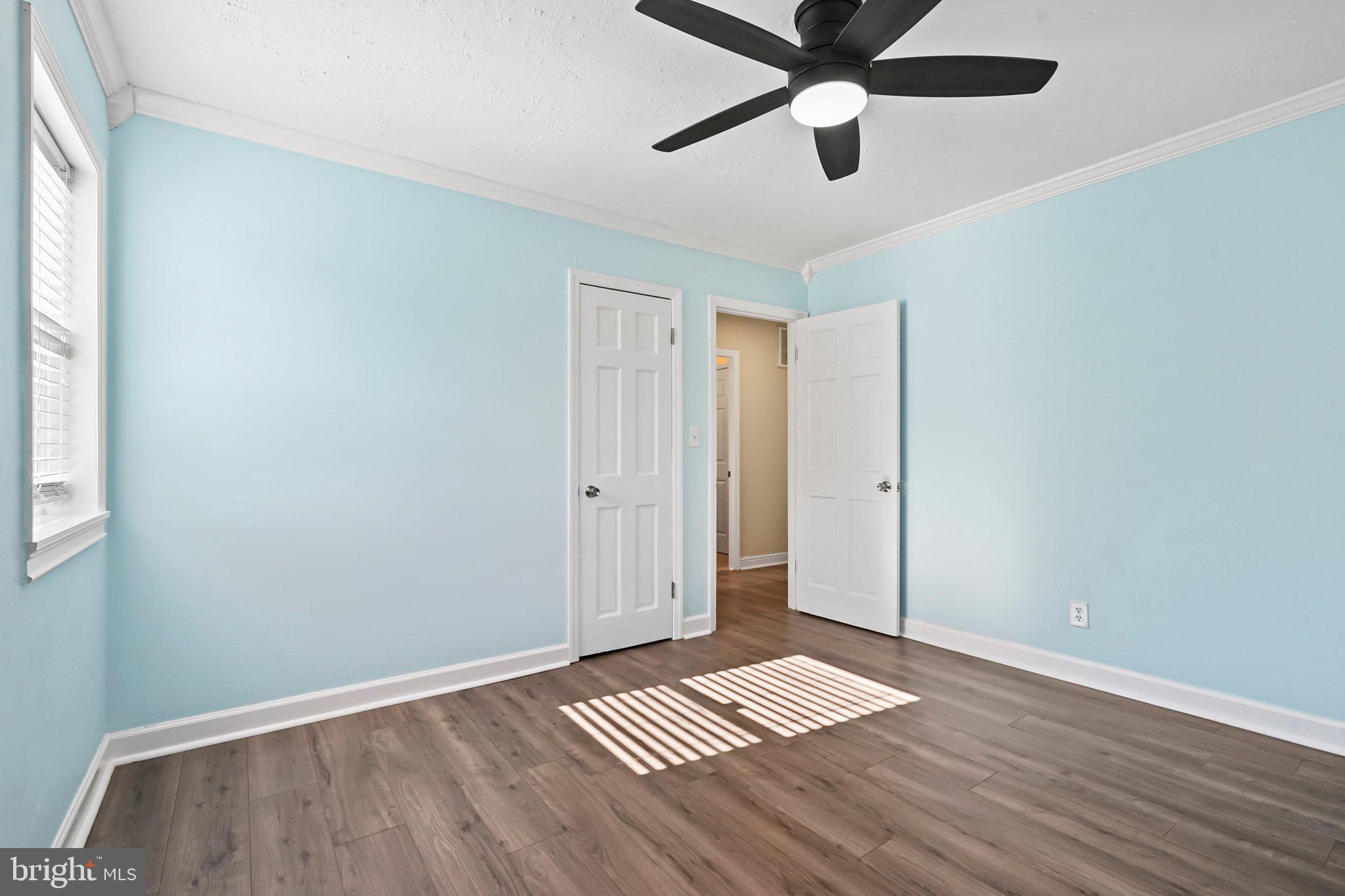 312 Wynnewood Road Ewing, NJ 08628 - Photo 11 of 24 a view of wooden floor and a chandelier fan in a room