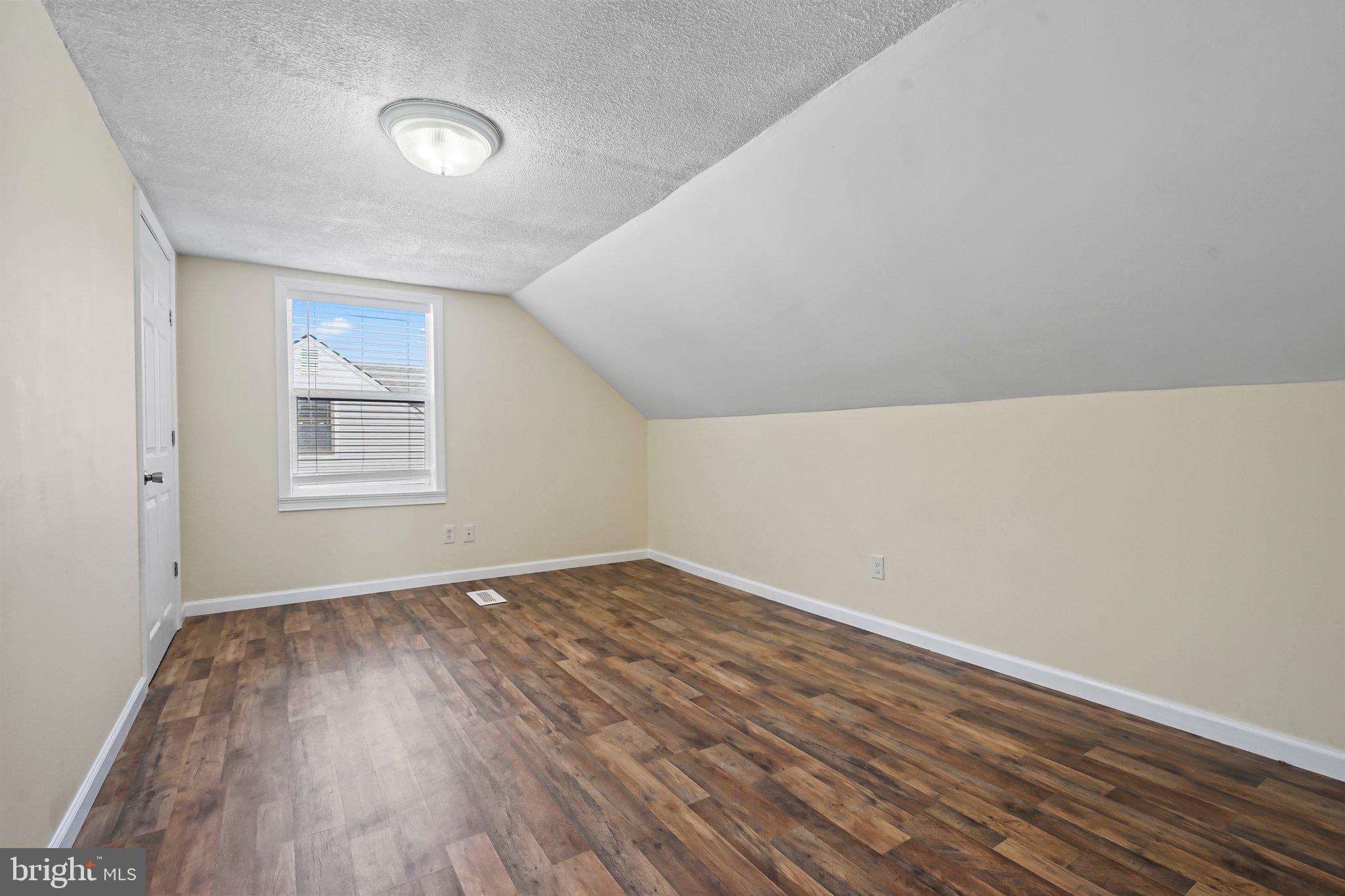 312 Wynnewood Road Ewing, NJ 08628 - Photo 12 of 24 a view of an empty room with wooden floor and a window