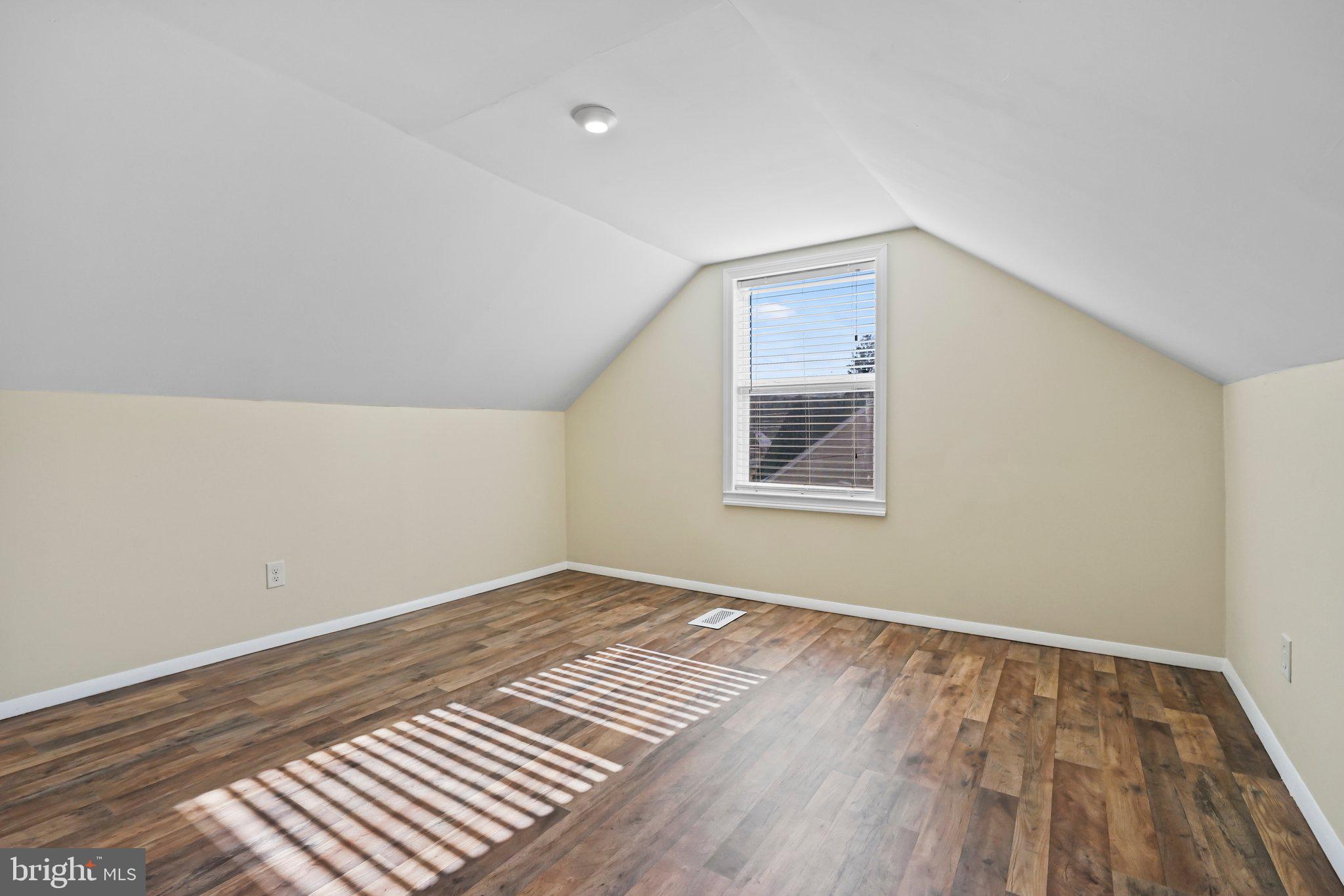312 Wynnewood Road Ewing, NJ 08628 - Photo 14 of 24 a view of an empty room with wooden floor and a window