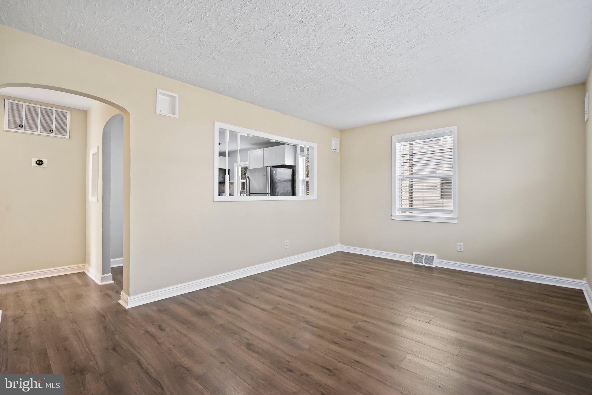 312 Wynnewood Road Ewing, NJ 08628 - Photo 2 of 24 a view of an empty room with wooden floor and a window