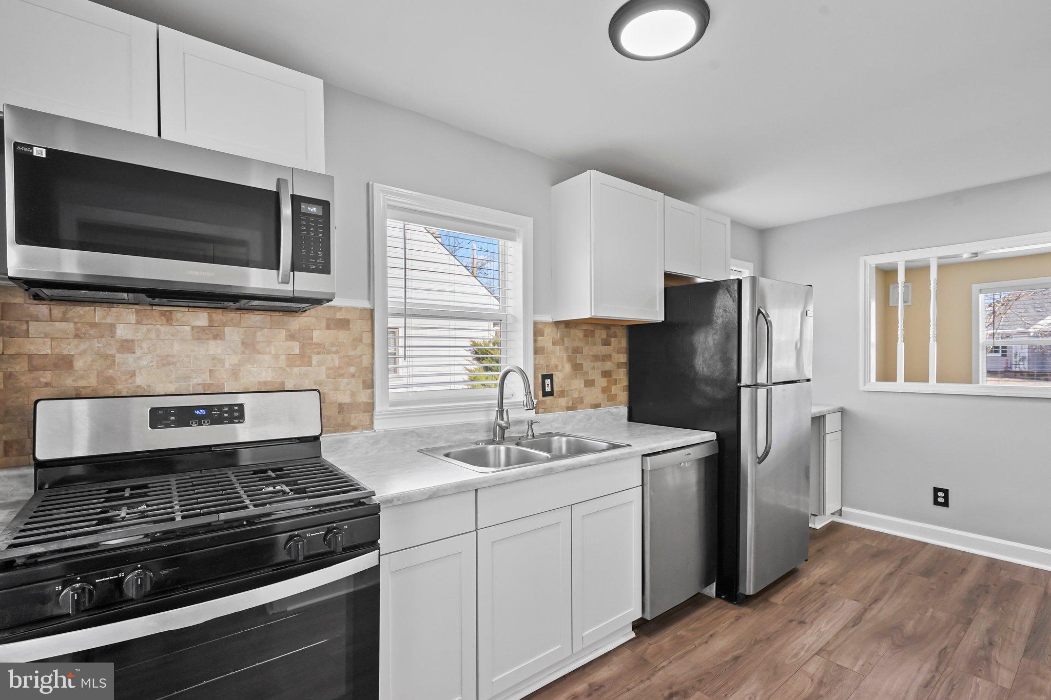 312 Wynnewood Road Ewing, NJ 08628 - Photo 5 of 24 a kitchen with stainless steel appliances a stove microwave and refrigerator