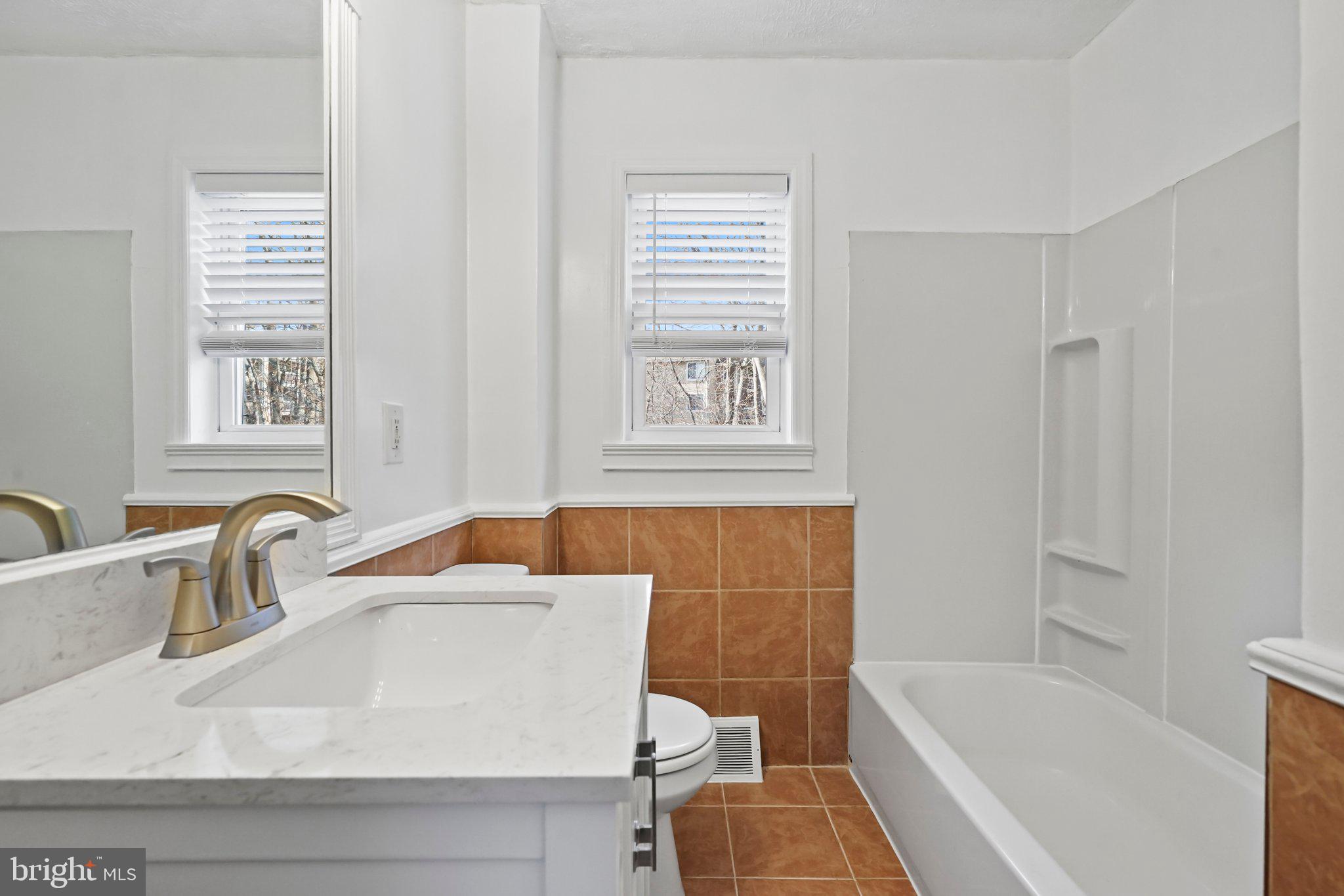 312 Wynnewood Road Ewing, NJ 08628 - Photo 7 of 24 a bathroom with a sink a bathtub and a window