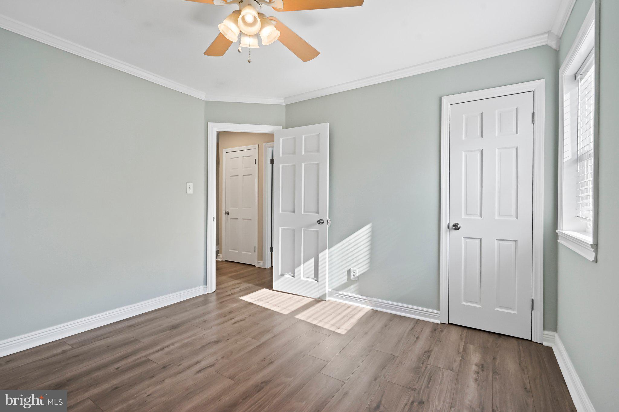 312 Wynnewood Road Ewing, NJ 08628 - Photo 9 of 24 an empty room with wooden floor and windows