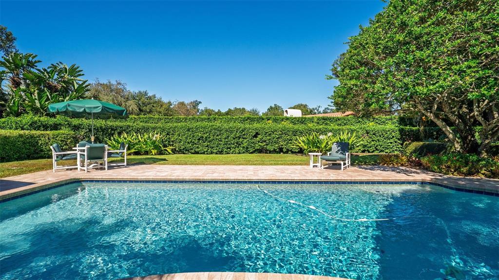 1053 Sweetbriar Road Orlando, FL 32806 - Photo 15 of 79 a view of a swimming pool with an outdoor space and seating area