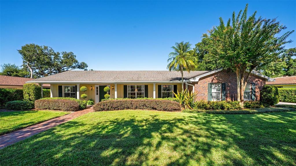 1053 Sweetbriar Road Orlando, FL 32806 - Photo 2 of 79 a front view of house with yard and green space