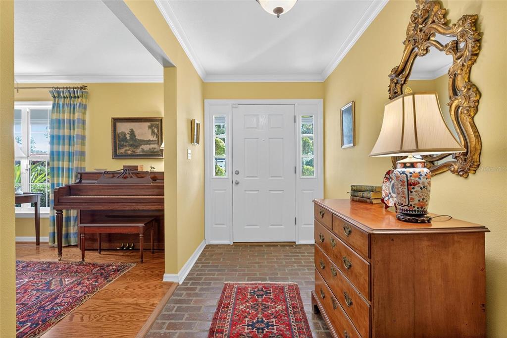 1053 Sweetbriar Road Orlando, FL 32806 - Photo 22 of 79 a view of hallway with a piano and wooden floor