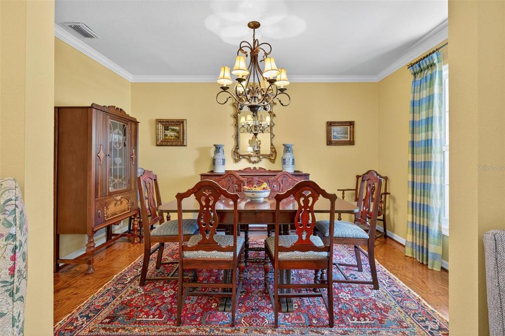 1053 Sweetbriar Road Orlando, FL 32806 - Photo 27 of 79 a view of a dining room with furniture and wooden floor