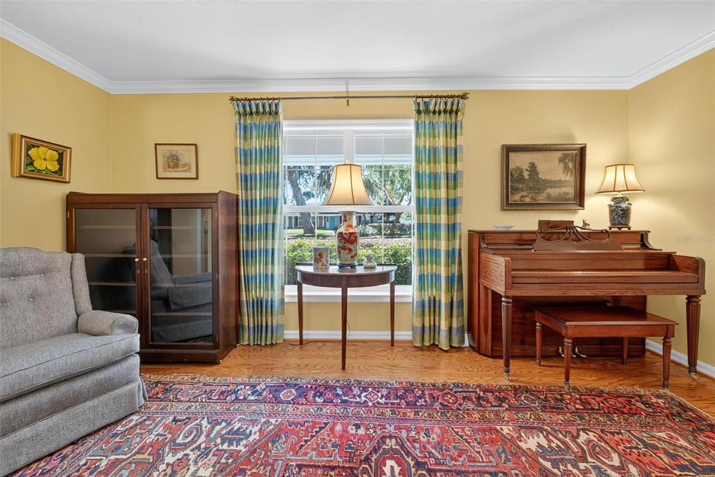 1053 Sweetbriar Road Orlando, FL 32806 - Photo 31 of 79 a living room with furniture and a piano