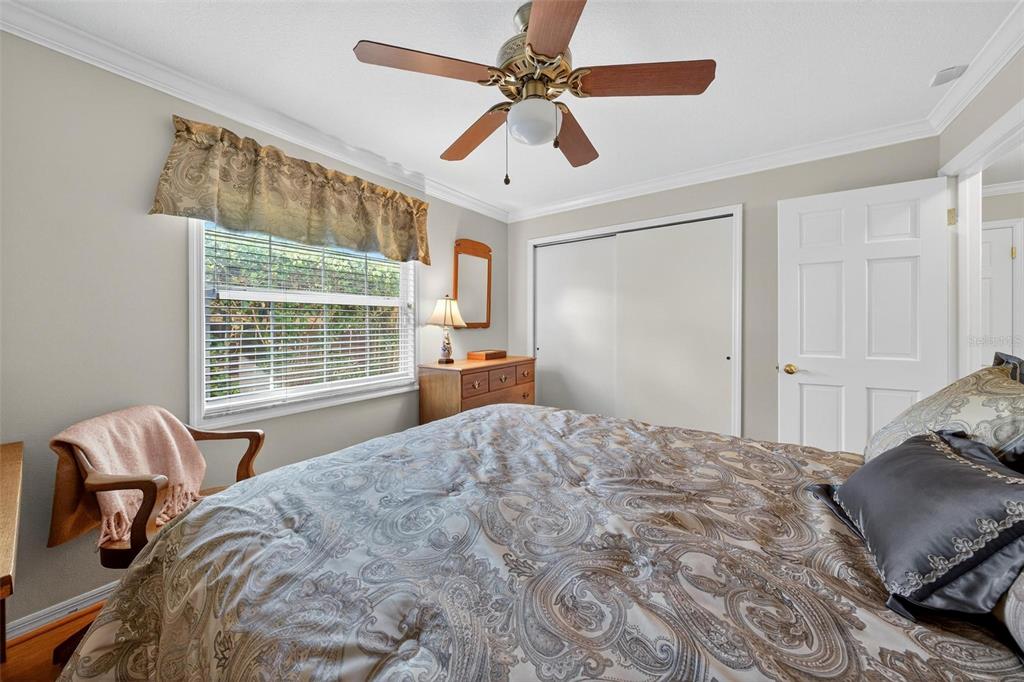 1053 Sweetbriar Road Orlando, FL 32806 - Photo 59 of 79 a bedroom with a bed and wooden floor
