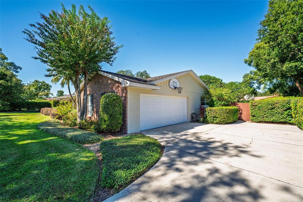 1053 Sweetbriar Road Orlando, FL 32806 - Photo 6 of 79 a front view of a house with a yard and garage
