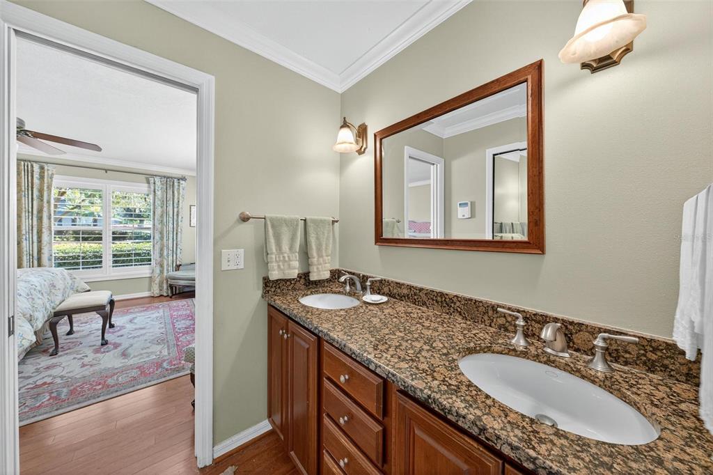 1053 Sweetbriar Road Orlando, FL 32806 - Photo 69 of 79 a en suite bathroom with a granite countertop sink and a mirror