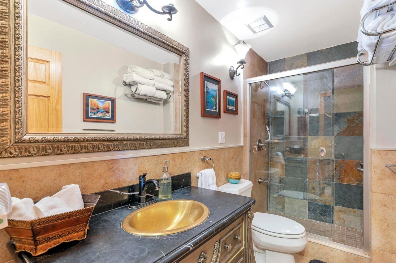 1001 Commonwealth Drive, Unit 156 Kings Beach, CA 96143 - Photo 14 of 21 a bathroom with a granite countertop sink and a mirror